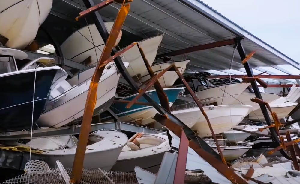 Boats on typical marina rack structure on Alabama Gulf Coast collapsed by hurricane winds, rain, storm surge, flooding