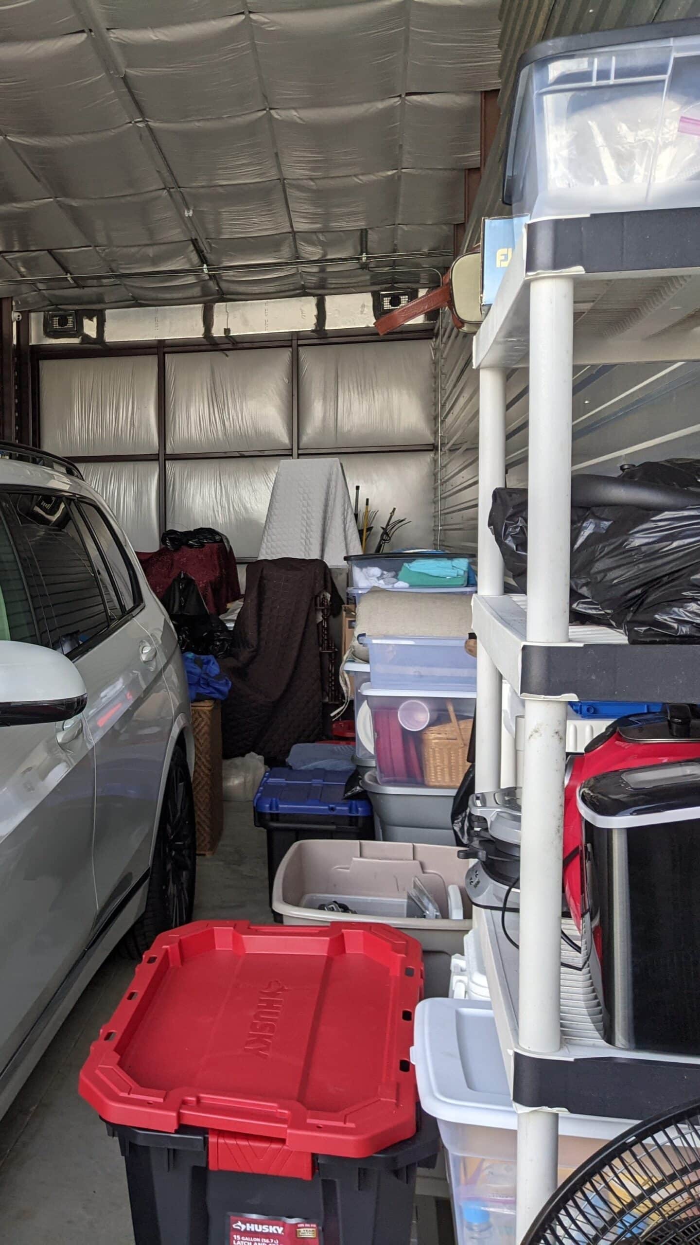 Oversized large self storage unit with household goods, furniture, and a car stored inside to demonstrate the size of the units at titan storage